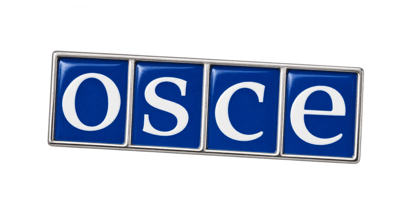 The OSCE emblem as a small blue enamel pin