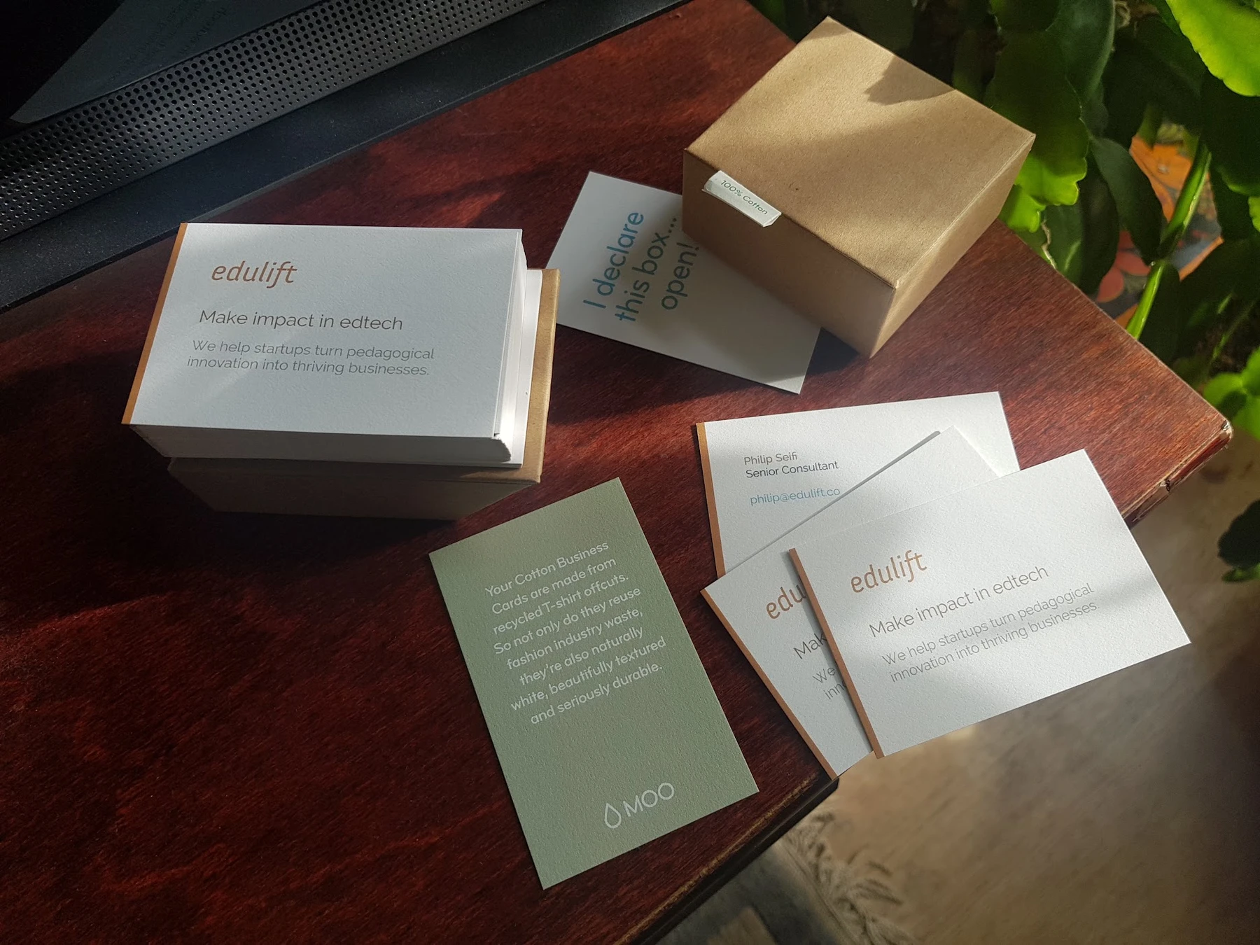 Philip Seifi's orange and white EduLift business cards, with the words Make impact in edtech.