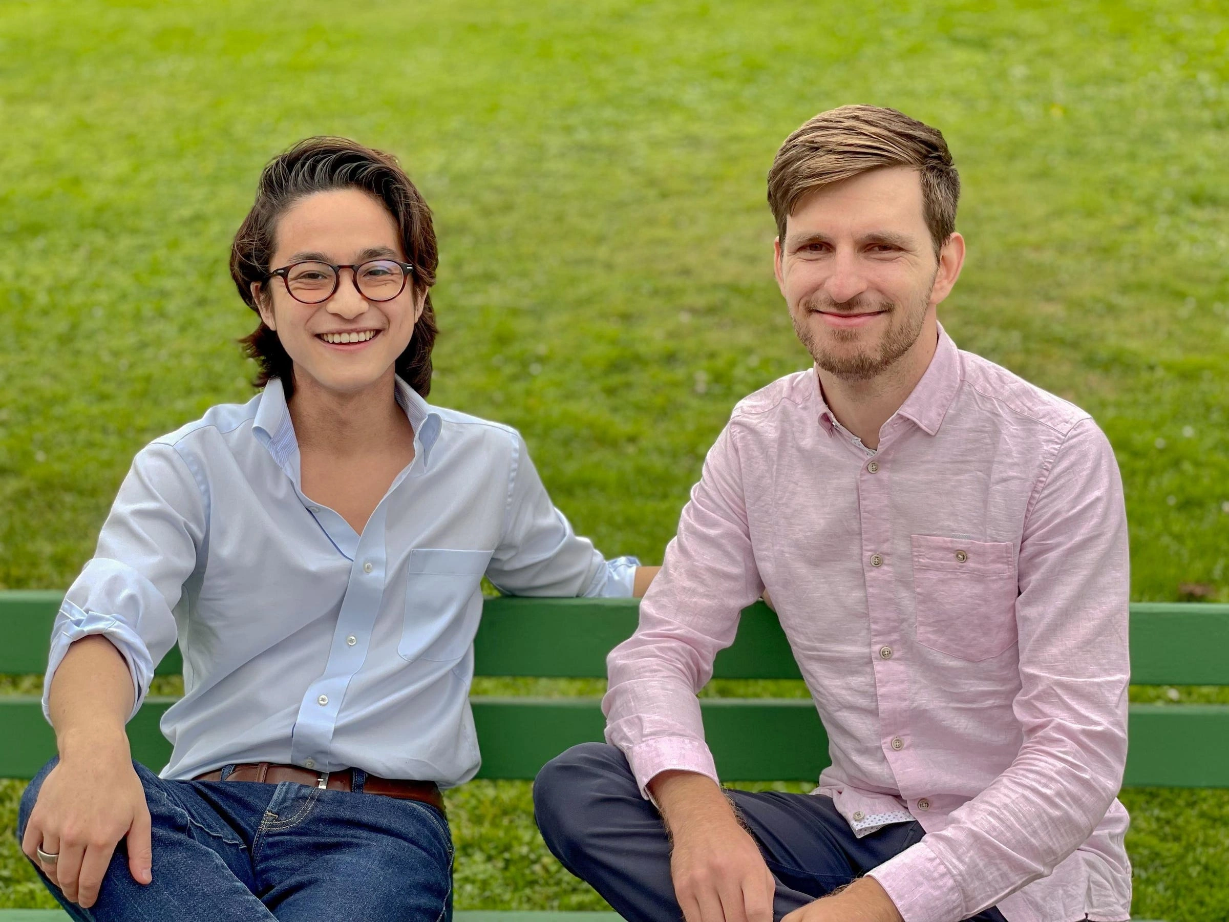Aoi Senju and Philip Seifi sitting together on a green park bench