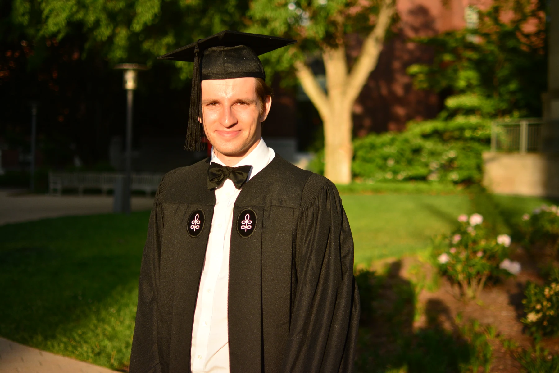 Graduation portrait in cap and gown outdoors