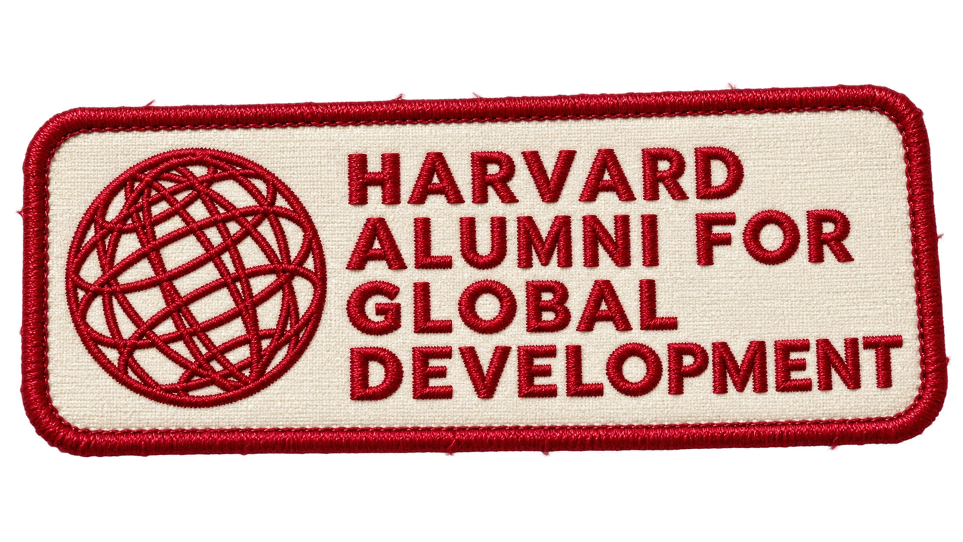 The Harvard Alumni for Global Development globe embroidered in crimson on a cloth patch